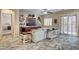 Bright living room with a large sectional sofa, wood-look tile floors and stylish wall decor at 7331 Abundant Harvest Ave, Las Vegas, NV 89131