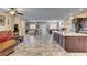 Open floor plan showing living room, kitchen, and dining area with cohesive flooring at 7331 Abundant Harvest Ave, Las Vegas, NV 89131