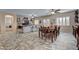 Open concept living room showcasing neutral paint colors, tile flooring, and dining area at 7331 Abundant Harvest Ave, Las Vegas, NV 89131