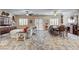 Open concept floor plan with dining area, living room, and patio doors with custom window coverings at 7331 Abundant Harvest Ave, Las Vegas, NV 89131