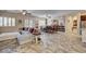 Open-concept living space with a large sectional sofa, tile floors and a dining area at 7331 Abundant Harvest Ave, Las Vegas, NV 89131