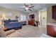 Spacious bedroom features a ceiling fan, shuttered windows, built-in cabinets, and convenient access to the en-suite bathroom at 7331 Abundant Harvest Ave, Las Vegas, NV 89131