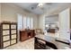 Office with desk, accent chair, storage cabinets and shutters at 7331 Abundant Harvest Ave, Las Vegas, NV 89131