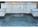 A luxurious pool water feature with a waterfall and fire feature at 7331 Abundant Harvest Ave, Las Vegas, NV 89131