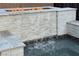 View of backyard pool with decorative stone waterfall feature, fire pit and pool water at 7331 Abundant Harvest Ave, Las Vegas, NV 89131