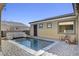 Backyard view featuring a swimming pool, patio furniture and side of house at 7331 Abundant Harvest Ave, Las Vegas, NV 89131