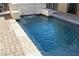 View of backyard pool with decorative stone waterfall feature, water and perimeter stone at 7331 Abundant Harvest Ave, Las Vegas, NV 89131