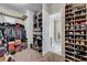Large walk-in closet with custom shelves, access to the bathroom and plenty of space for shoes at 7331 Abundant Harvest Ave, Las Vegas, NV 89131