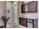 Stylish wet bar area with dark cabinets, granite countertops, and a mini fridge, ideal for entertaining at 7331 Abundant Harvest Ave, Las Vegas, NV 89131