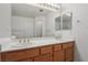 Bathroom with a dual sink vanity and large mirror, providing ample space at 7501 Bush Garden Ave, Las Vegas, NV 89129