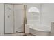 Elegant bathroom featuring a shower, soaking tub, and large window at 7501 Bush Garden Ave, Las Vegas, NV 89129
