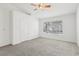 Bedroom with a window, neutral carpet, ceiling fan, and ample natural light at 7501 Bush Garden Ave, Las Vegas, NV 89129