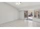This light and bright bedroom features a sliding glass door and tiled floors at 7501 Bush Garden Ave, Las Vegas, NV 89129