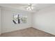 Bedroom featuring carpet, a ceiling fan with lights, and a window with neighborhood views at 7501 Bush Garden Ave, Las Vegas, NV 89129