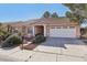 Charming single-story home featuring a well-manicured yard and a two-car garage at 7501 Bush Garden Ave, Las Vegas, NV 89129