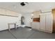 Spacious garage with ample storage cabinets, utility sink, and access door at 7501 Bush Garden Ave, Las Vegas, NV 89129
