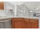 Open kitchen concept with tile countertops, oak cabinetry, and views to the backyard at 7501 Bush Garden Ave, Las Vegas, NV 89129