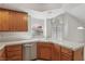 Bright kitchen featuring oak cabinets, tile countertops, and a stainless steel dishwasher at 7501 Bush Garden Ave, Las Vegas, NV 89129