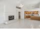 Open living room with tile floors, fireplace, and access to the kitchen at 7501 Bush Garden Ave, Las Vegas, NV 89129