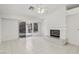 Bright living room features tile floors, fireplace, and sliding door access to the outdoors at 7501 Bush Garden Ave, Las Vegas, NV 89129