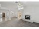 Open concept living room with fireplace, plush carpet and elegant columns at 7501 Bush Garden Ave, Las Vegas, NV 89129
