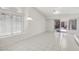Light-filled living room with tile floors, large window, and access to backyard at 7501 Bush Garden Ave, Las Vegas, NV 89129