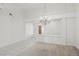 Bright living room with neutral paint, plush carpet, tiled floors and elegant chandelier at 7501 Bush Garden Ave, Las Vegas, NV 89129