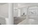 Open-concept living room with a fireplace, large window, and white pillars at 7501 Bush Garden Ave, Las Vegas, NV 89129