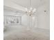 Spacious living room with large windows and a ceiling fan and elegant chandelier at 7501 Bush Garden Ave, Las Vegas, NV 89129