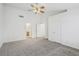 View of a Primary bedroom with a ceiling fan, neutral carpet, and access to the bathroom at 7501 Bush Garden Ave, Las Vegas, NV 89129