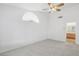 Spacious Primary bedroom featuring neutral carpet, a ceiling fan, and natural light at 7501 Bush Garden Ave, Las Vegas, NV 89129