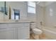 Tiled bathroom with a shower-tub combo, toilet, and a vanity with a large mirror at 7517 Cliff Peaks St, Las Vegas, NV 89149