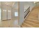 Inviting entryway featuring a staircase, light hardwood floors, and a double door entry at 7517 Cliff Peaks St, Las Vegas, NV 89149