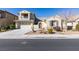 Two-story home featuring desert landscaping, two-car garage, and stucco walls, accented with a small balcony and tiled roof at 7517 Cliff Peaks St, Las Vegas, NV 89149