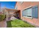 The patio area features turf and access to the home's interior through sliding glass doors at 7815 Red Rock Ridge Ave, Las Vegas, NV 89179
