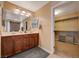 Bathroom with a double sink vanity, large mirror, and storage options, plus walk-in closet at 7815 Red Rock Ridge Ave, Las Vegas, NV 89179