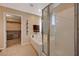 Elegant bathroom featuring a soaking tub, glass-enclosed shower, and accessible walk-in closet at 7815 Red Rock Ridge Ave, Las Vegas, NV 89179