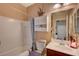 Clean bathroom featuring a vanity with a white sink, a mirror, and a shower-tub combo at 7815 Red Rock Ridge Ave, Las Vegas, NV 89179