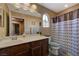 Bathroom featuring a vanity with sink and commode, window over the sink, and a shower/tub combination at 7815 Red Rock Ridge Ave, Las Vegas, NV 89179