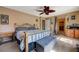 Inviting bedroom with ceiling fan, coordinated decor, and convenient access to a walk-in closet at 7815 Red Rock Ridge Ave, Las Vegas, NV 89179