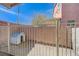 Fenced dog run with gravel substrate and a small dog house provides space for pets at 7815 Red Rock Ridge Ave, Las Vegas, NV 89179