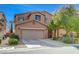 Two story home with a two car garage, desert landscaping, and attractive architectural details at 7815 Red Rock Ridge Ave, Las Vegas, NV 89179
