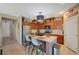 Open-concept kitchen featuring an island with seating and stainless steel appliances at 7815 Red Rock Ridge Ave, Las Vegas, NV 89179