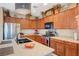 Stylish kitchen with wooden cabinetry, a center island, and modern appliances at 7815 Red Rock Ridge Ave, Las Vegas, NV 89179