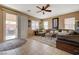 Cozy living room with natural light, tile floors and backyard access through sliding glass door at 7815 Red Rock Ridge Ave, Las Vegas, NV 89179