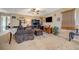 Bright and airy living room with a sofa, ottoman, desk, and a ceiling fan at 7815 Red Rock Ridge Ave, Las Vegas, NV 89179
