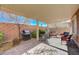 Comfortable paver patio area includes a grill, mature trees, and a brick privacy wall at 7815 Red Rock Ridge Ave, Las Vegas, NV 89179