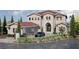 Elegant two-story home featuring a stone facade, red tile roof, and meticulously landscaped front yard at 8 Via Verona Ct, Henderson, NV 89011