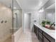 Modern bathroom with tiled shower, glass door, and double vanity with plants at 817 Great Sky Ct, North Las Vegas, NV 89084