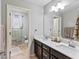 Bathroom featuring double sink vanity, quartz countertop, and tile floors at 817 Great Sky Ct, North Las Vegas, NV 89084